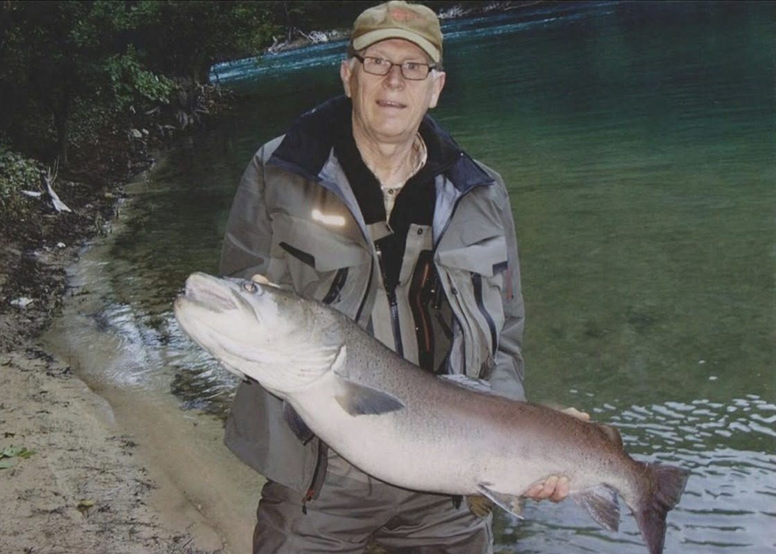 Emir Ceric’s dad holding a very large fish by a river